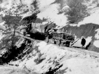 D-05721: Trucks on Icy Uphill, Mission Mountain Road, 1940s