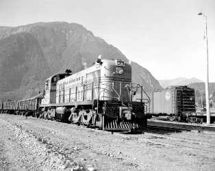 BC Archives # I-29061 - PGE Diesel Locomotive at Lillooet Station, flank of Mt. Brew in Background