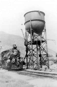 BC Archives # E-04478, PGE Locomotive No. 58 at the Lillooet Yard Water-tower, 1940s